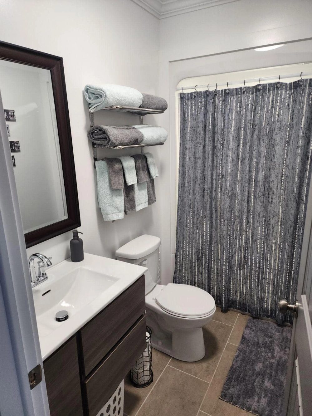 Unit A bathroom, clean and stocked with body wash, shampoo and a blow dryer.