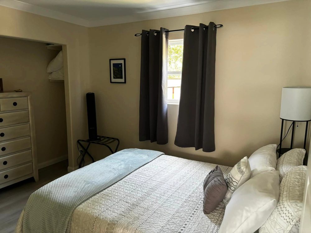 A second cozy, freshly made bedroom inside one of the suites.