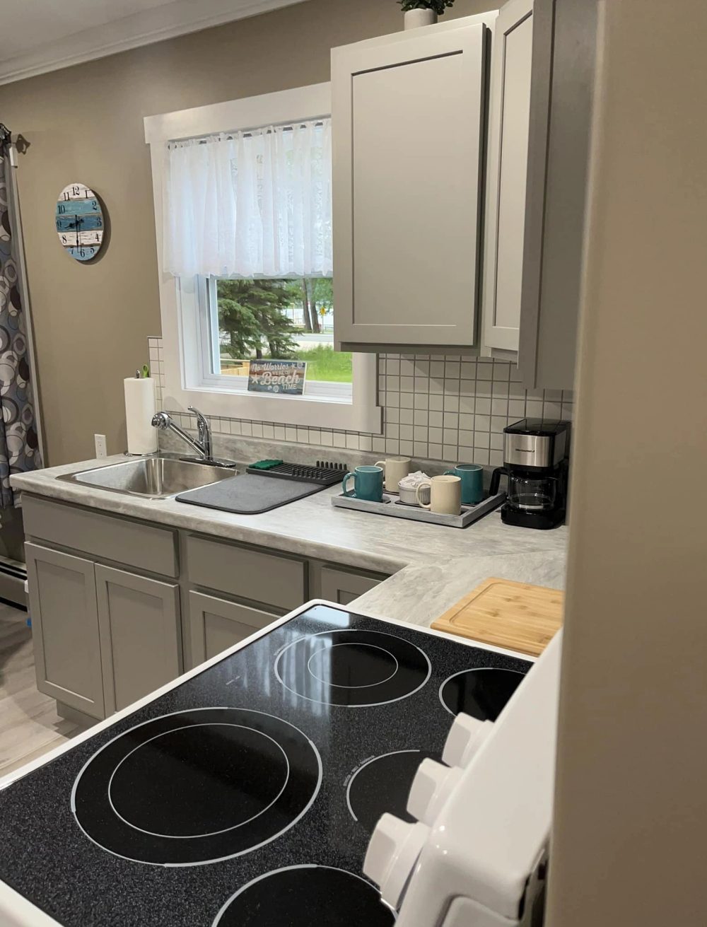 Unit A kitchen, fully stocked with coffee maker, air fryer and stove.
