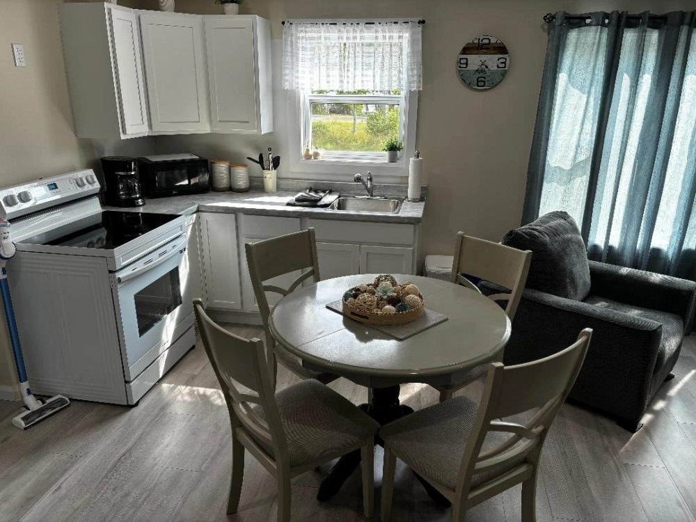 Unit B kitchen, fully stocked with coffee maker and stove.