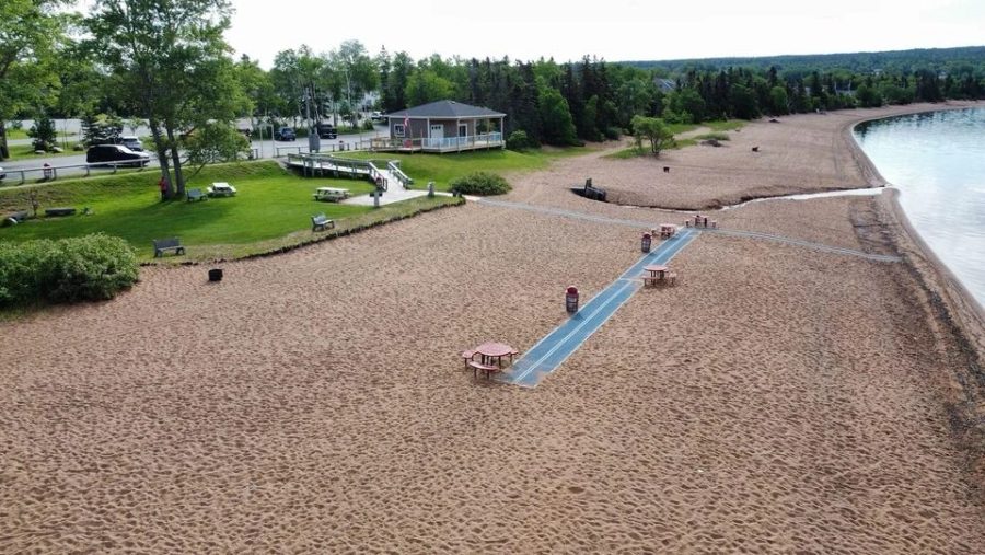Deer Lake Beach directly across the street from the suites, calm water and open sky.