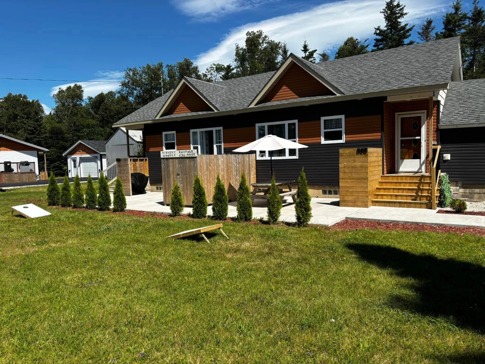 Exterior of the By The Beach suites in Deer Lake, a bright home set directly across the road from the beach.